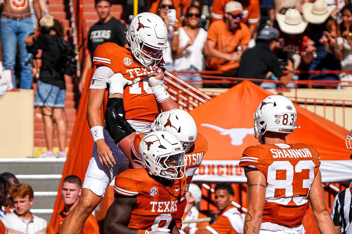 Texas Longhorns offensive lineman Conner Robertson (62) lifts quarterback Arch Manning (16) to celebrate a rushing toughdown during the game against Colorado State at Darrell K Royal-Texas Memorial Stadium in Austin Saturday, Aug. 31, 2024.