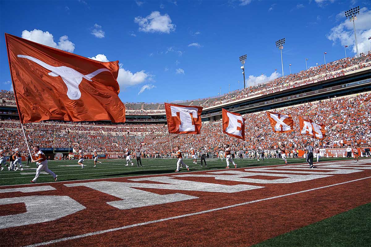 Texas Longhorns cheerleaders run flags across the endoze after a score in the game against Colorado State at Darrell K Royal-Texas Memorial Stadium