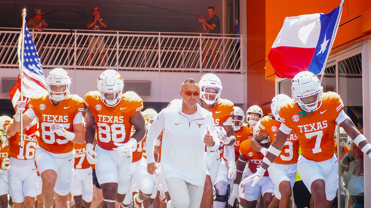 Texas Longhorns Head Coach Steve Sarkisian leads his team out onto the field at Darrell K Royal-Texas Memorial Stadium.