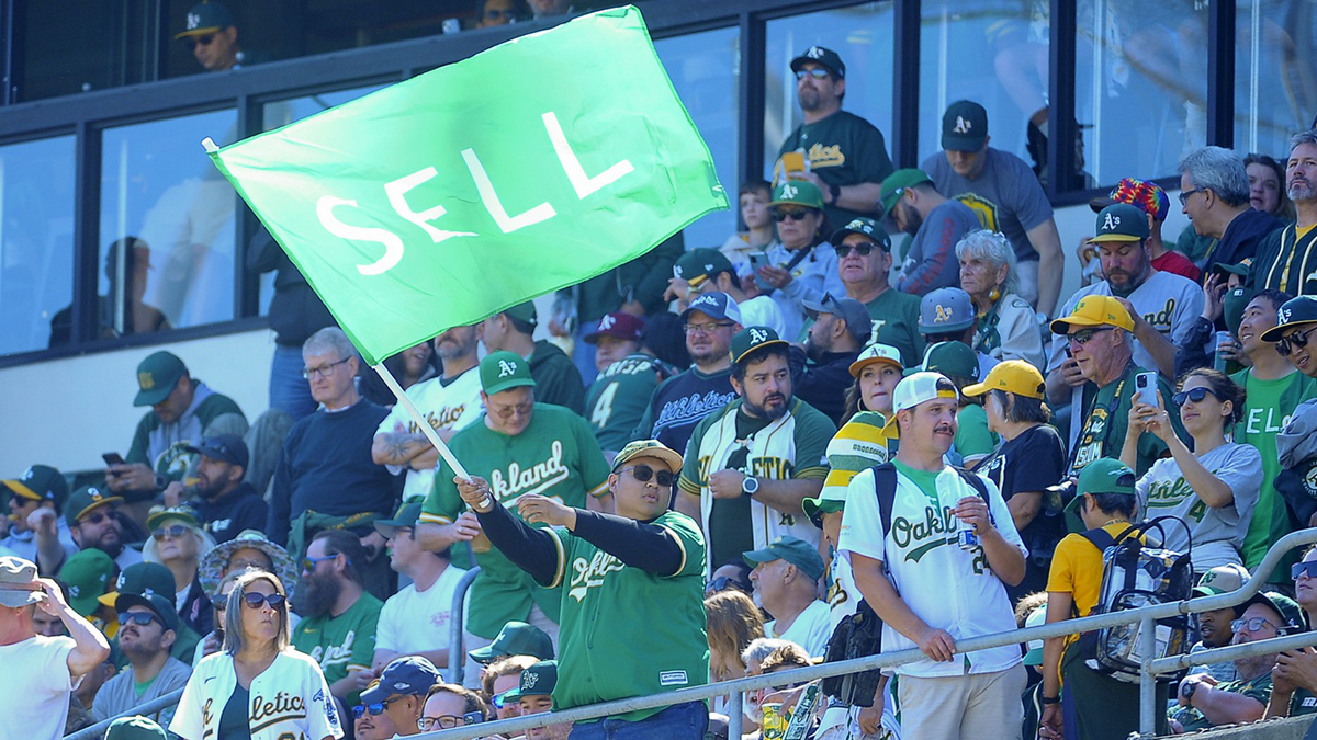 An Oakland Athletics fan waves a flag before the game against the Texas Rangers at Oakland-Alameda County Coliseum.