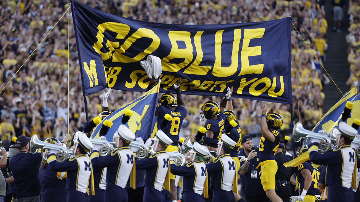 Michigan Wolverines players take the field before a game against the Fresno State Bulldogs at Michigan Stadium.