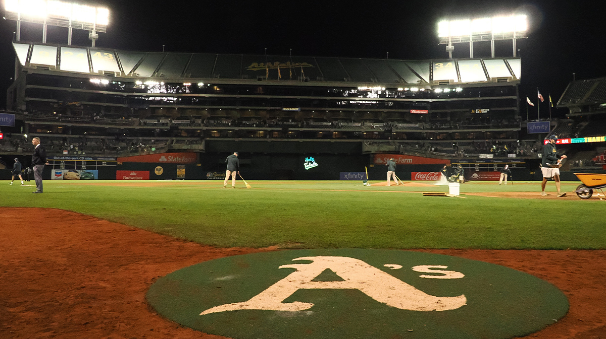 The Oakland Athletics on deck circle after the game against the Texas Rangers at Oakland-Alameda County Coliseum. Security have caught fans stealing seats from the stadium as souvenirs.