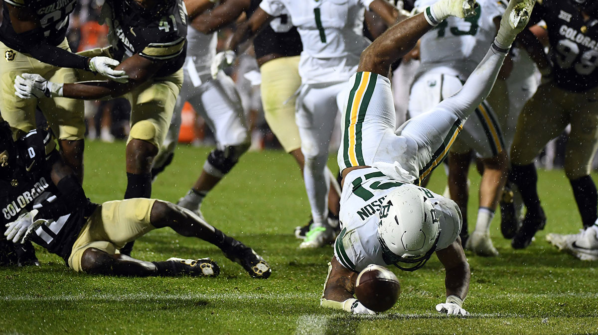 Baylor Bears running back Dominic Richardson (21) fumbles the ball out of the end zone after a hit by Colorado Buffaloes wide receiver Travis Hunter (12) in overtime at Folsom Field.