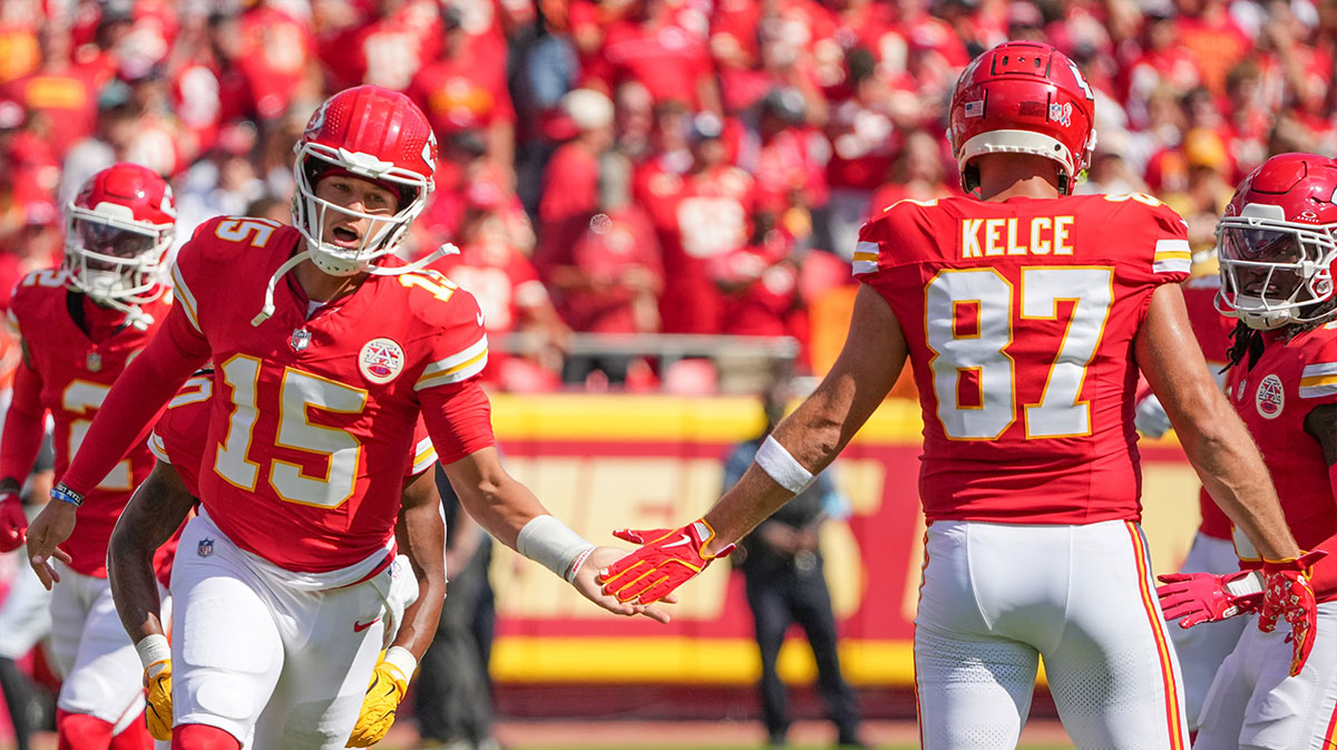 Kansas City Chiefs quarterback Patrick Mahomes (15) greets tight end Travis Kelce (87) during player introductions against the Cincinnati Bengals prior to a game at GEHA Field at Arrowhead Stadium.