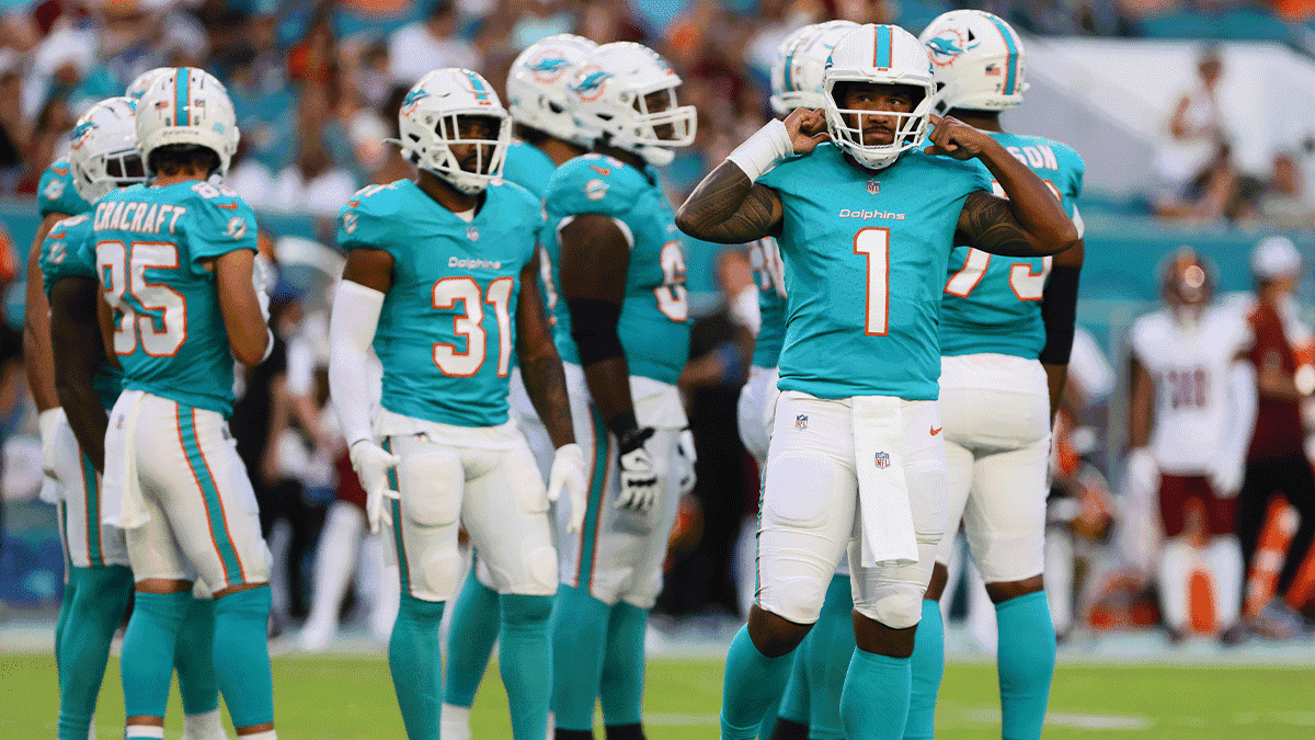 Miami Dolphins quarterback Tua Tagovailoa (1) looks on from the field against the Washington Commanders during the first quarter of a preseason game at Hard Rock Stadium