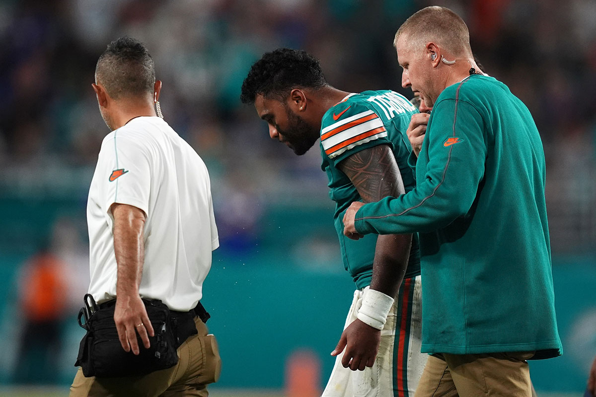 Miami Dolphins quarterback Tua Tagovailoa (1) leaves the field with the training staff after an injury believed to have occurred during the second half against the Buffalo Bills at Hard Rock Stadium.