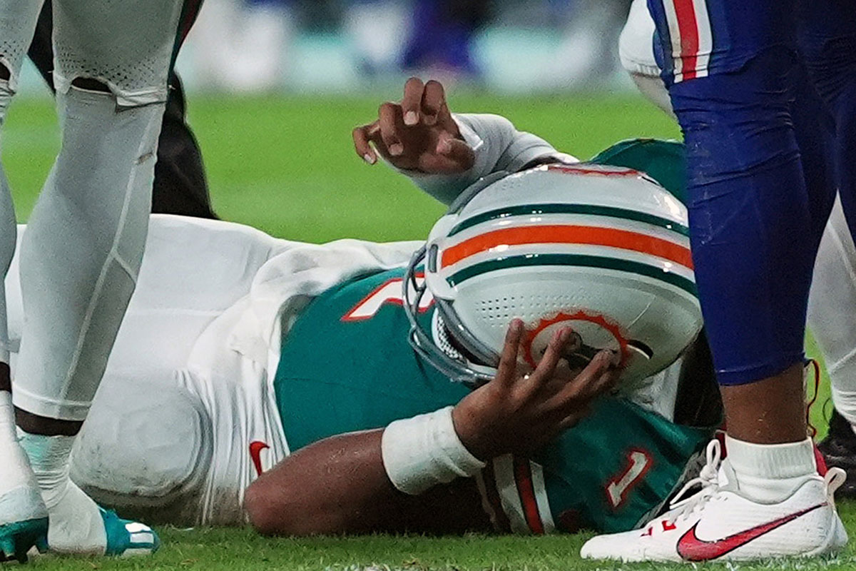 Miami Dolphins quarterback Tua Tagovailoa (1) sufferes an apparent concussion after hitting his head on the ground while being tackled by Buffalo Bills safety Damar Hamlin (3) during the second half at Hard Rock Stadium.