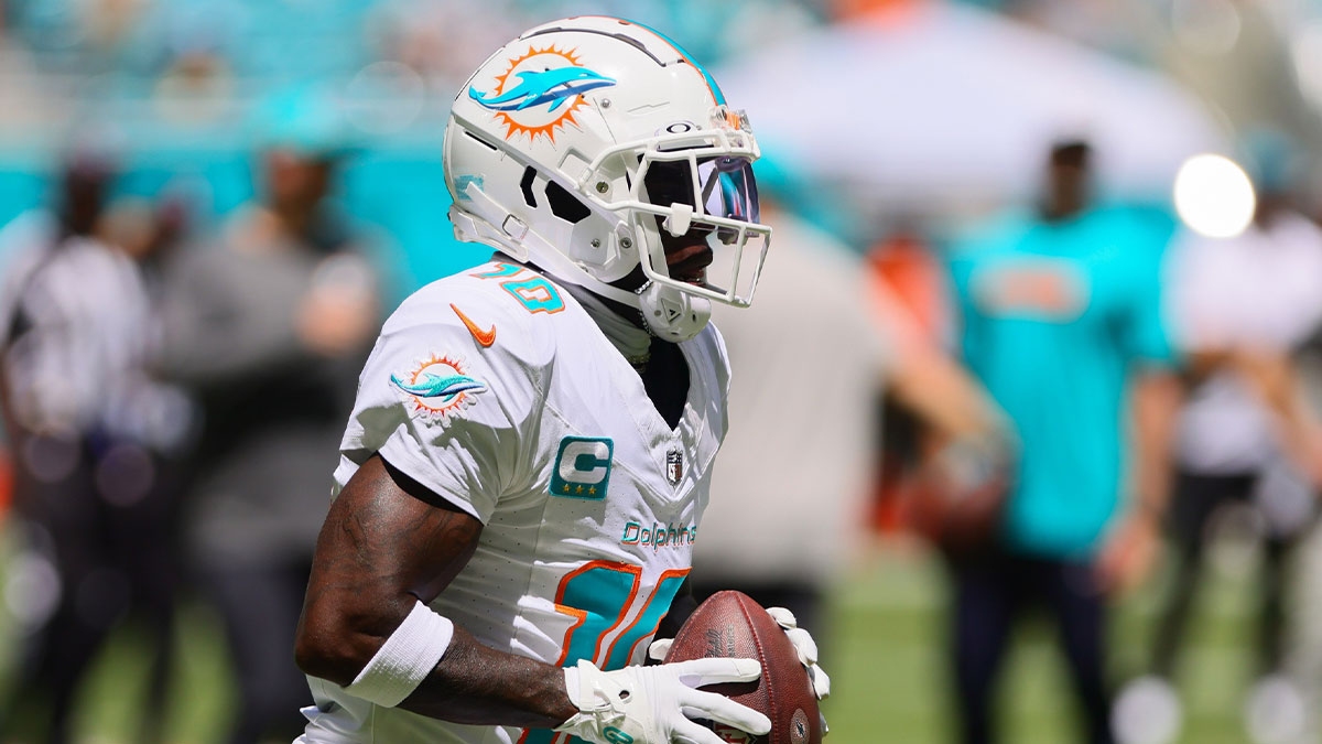 Miami Dolphins wide receiver Tyreek Hill (10) runs with the football before the game against the Jacksonville Jaguars at Hard Rock Stadium