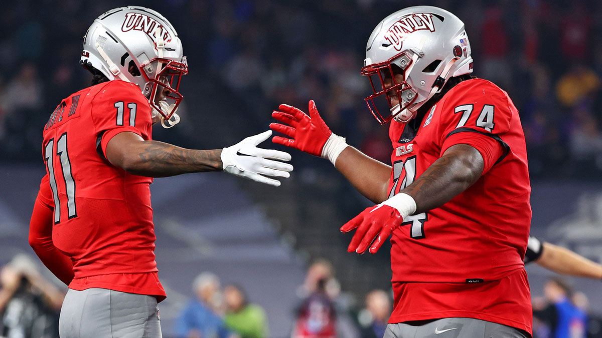 UNLV Rebels wide receiver Ricky White (11) celebrates with offensive lineman Jalen St. John (74) after scoring a touchdown during the third quarter against the Kansas Jayhawks in the Guaranteed Rate Bowl at Chase Field. 