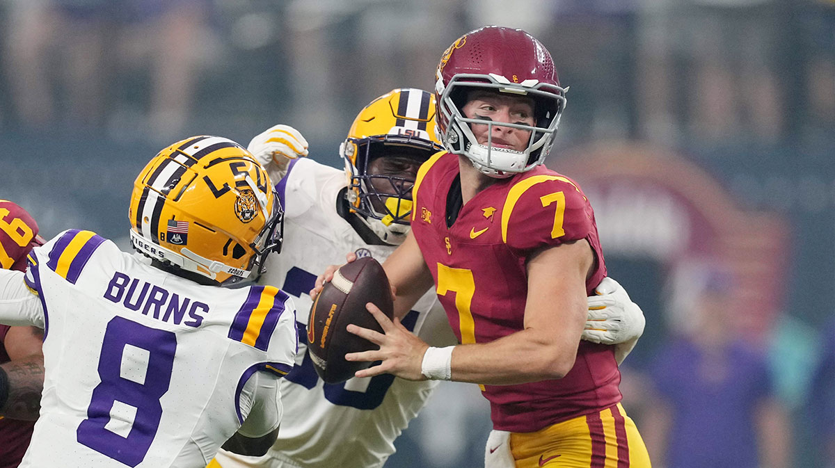 Southern California Trojans quarterback Miller Moss (7) is pressured by LSU Tigers safety Major Burns (8) and tight end Gabe Leonards (85) in the first half at Allegiant Stadium.