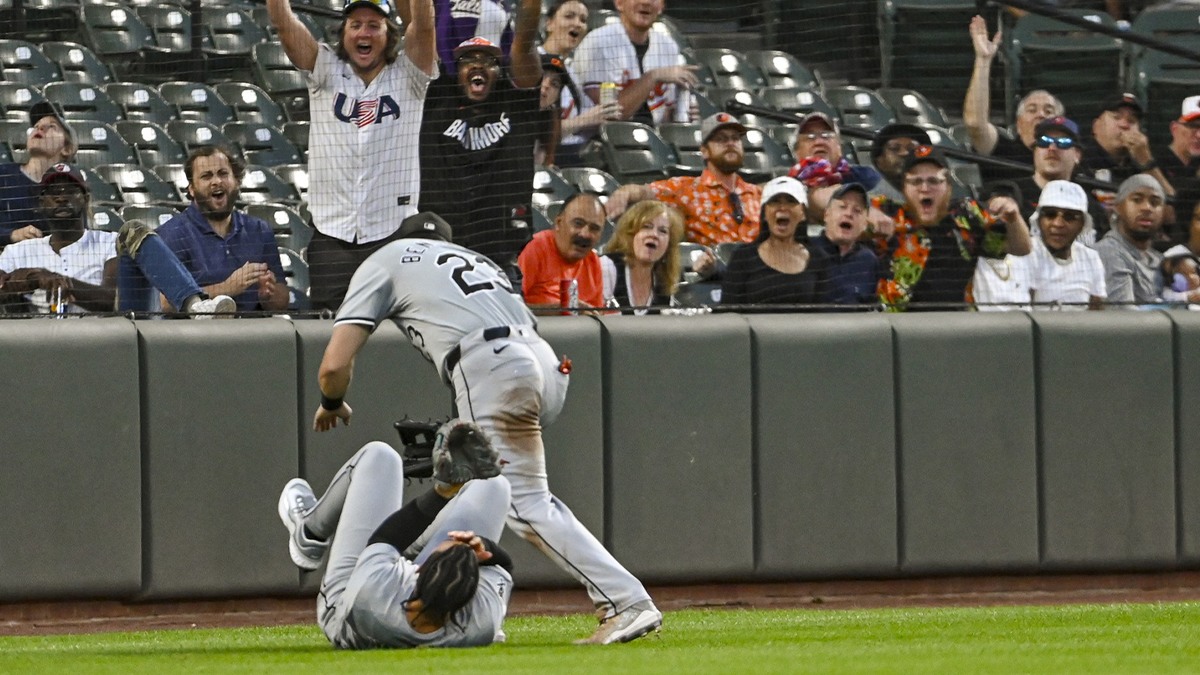 Sep 3, 2024; Baltimore, Maryland, USA; Chicago White Sox outfielder Miguel Vargas (20) and outfielder Andrew Benintendi (23) react after colliding on Baltimore Orioles designated hitter Eloy Jiménez (not pictured) second inning fly ball at Oriole Park at Camden Yards.