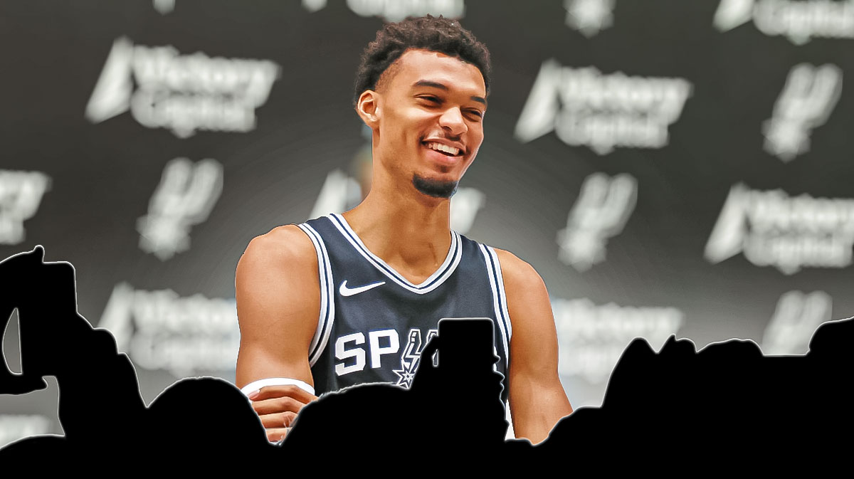 Victor Wembanyama image, silhouttes of reporters sitting asking him questions, spurs logo