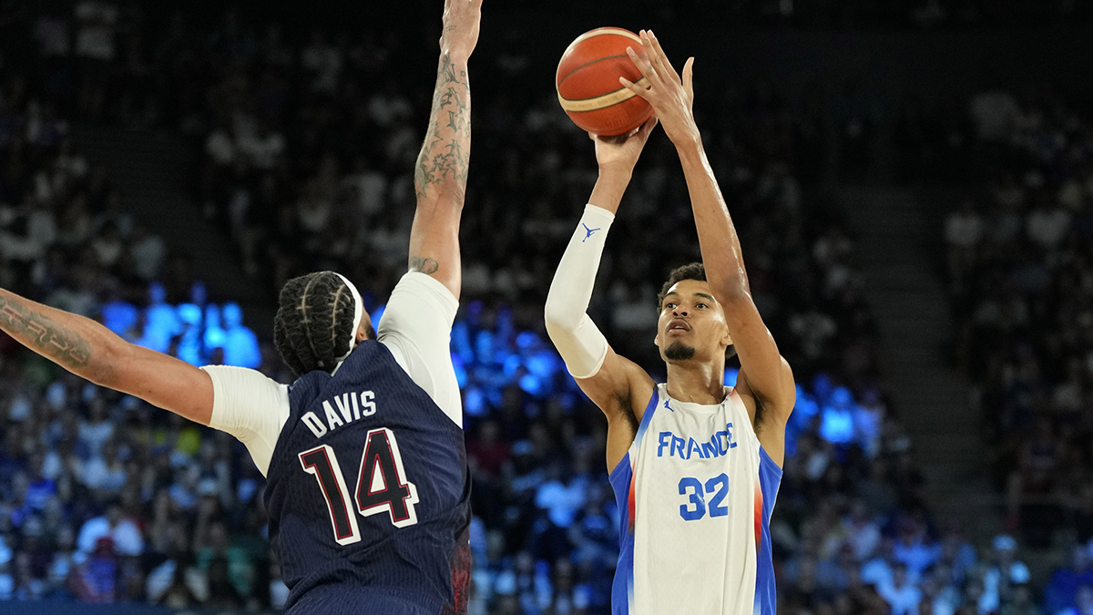 France power forward Victor Wembanyama (32) shoots against United States center Anthony Davis (14) in the second half of the men's basketball gold medal match at the Paris 2024 Summer Olympic Games at Accor Arena.