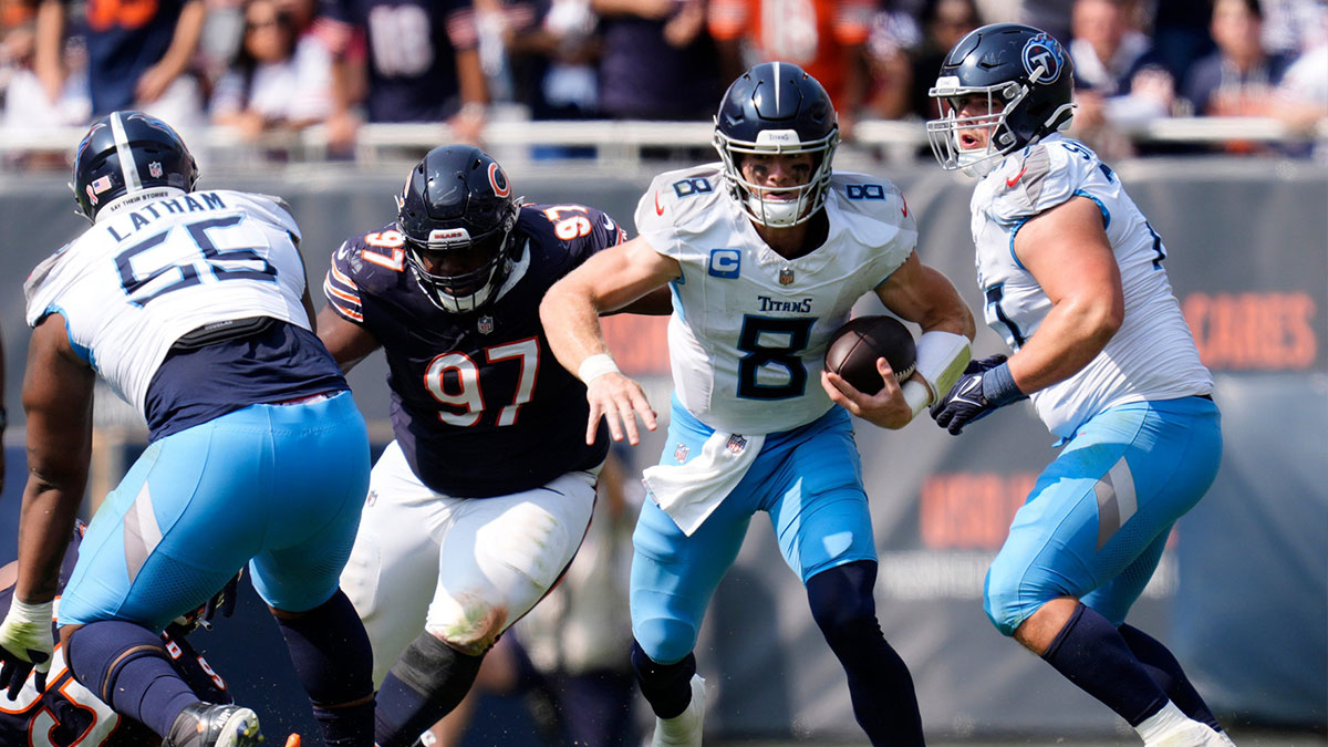 Tennessee Titans quarterback Will Levis (8) runs from Chicago Bears defensive tackle Andrew Billings (97) during the fourth quarter at Soldier Field in Chicago, Ill., Sunday, Sept. 8, 2024.