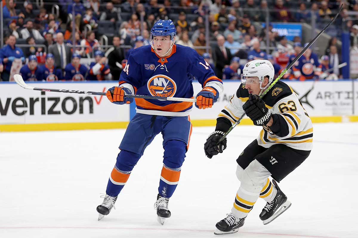 New York Islanders right wing William Dufour (14) skates against Boston Bruins left wing Brad Marchand (63) during the first period at UBS Arena.
