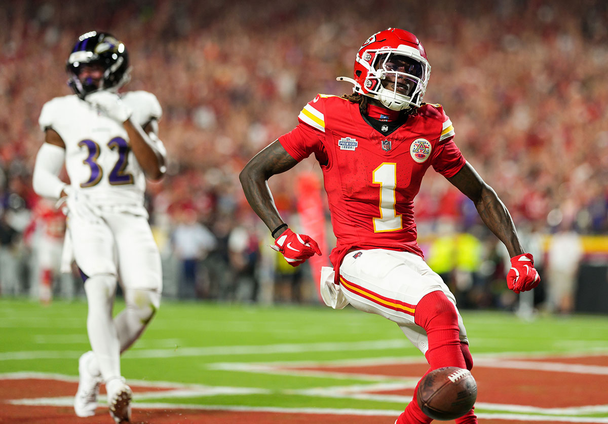 Kansas City Chiefs wide receiver Xavier Worthy (1) scores a touchdown against Baltimore Ravens safety Marcus Williams (32) during the first half at GEHA Field at Arrowhead Stadium.