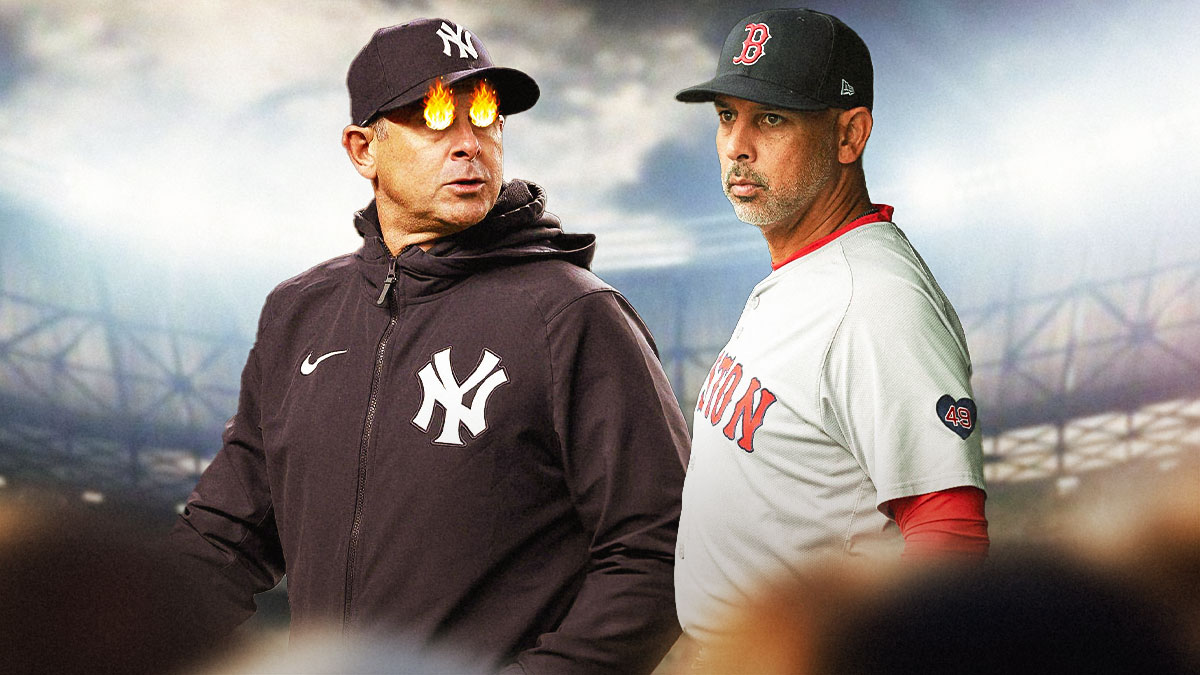 Aaron Boone with fire on his eyes looking at Alex Cora. Yankee Stadium in the background