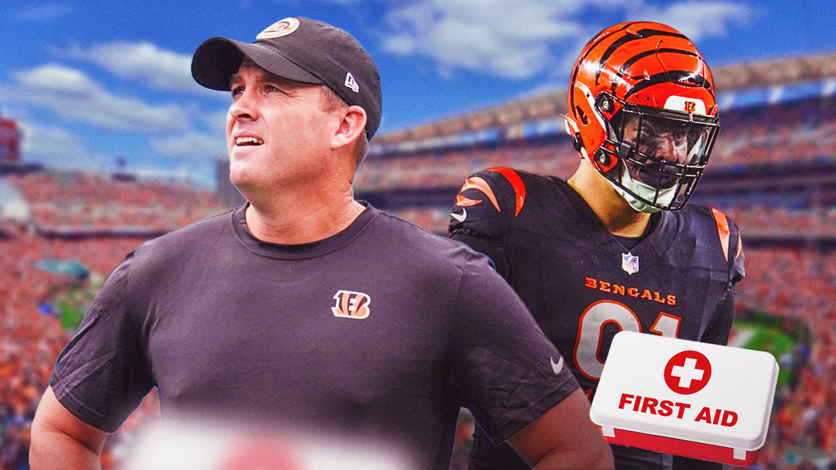 Bengals coach Zac Taylor and Trey Hendrickson in a Cincinnati Bengals uniform with a red and white first aid symbol as Hendrickson got banged up in Week Four with an injury, another of the bengals injuries.