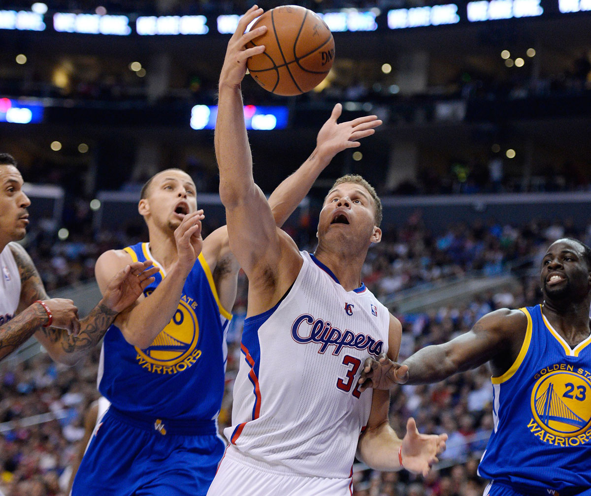 los angeles clippers forward blake griffin (32) grabs a rebound away from golden state warriors guard stephen curry (30) during 4th quarter action in game five of the first round of the 2014 nba playoffs at staples center.