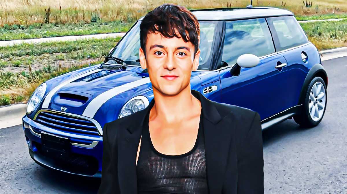 Tom Daley in front of a car from his collection.