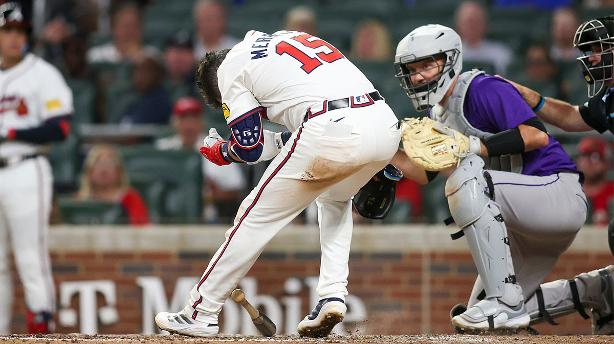 Atlanta Braves second baseman Whit Merrifield (15) is hit in the head with a pitch against the Colorado Rockies in the seventh inning at Truist Park.