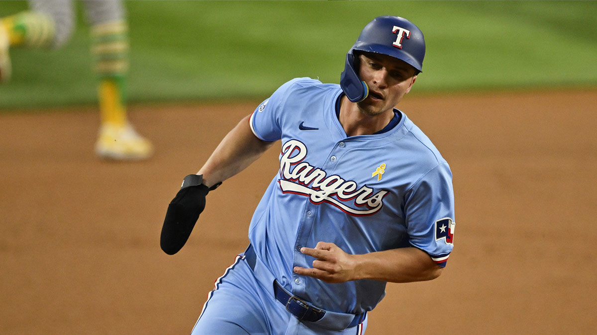 Texas Rangers shortstop Corey Seager (5) scores from second base on a double hit by right fielder Adolis Garcia (not pictured) during the first inning at Globe Life Field.
