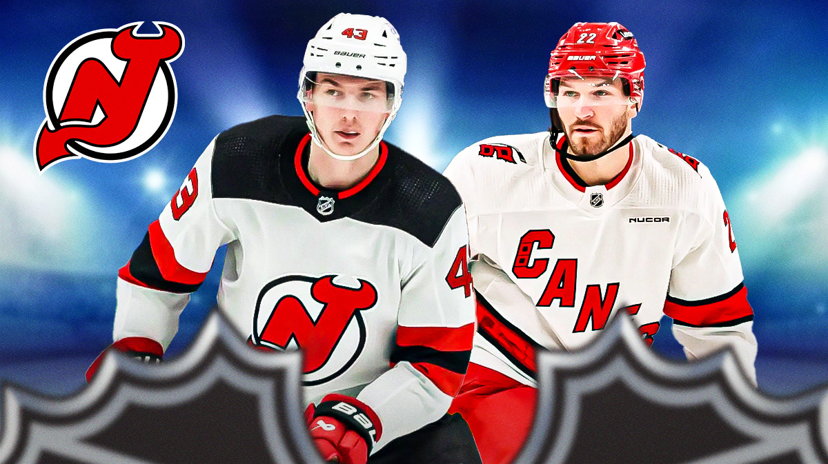 Luke Hughes and Brett Pesce with Devils logo behind them