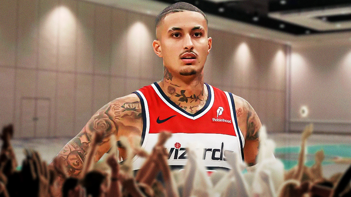 Kyle Kuzma in Wizards gear looks off into the distance, deep in thought