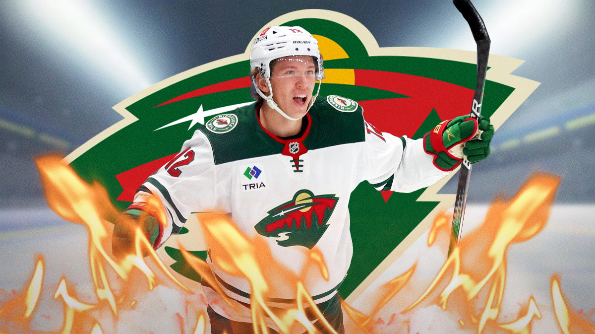 Matt Boldy in image looking happy with fire around him, Minnesota Wild logo, hockey rink in background