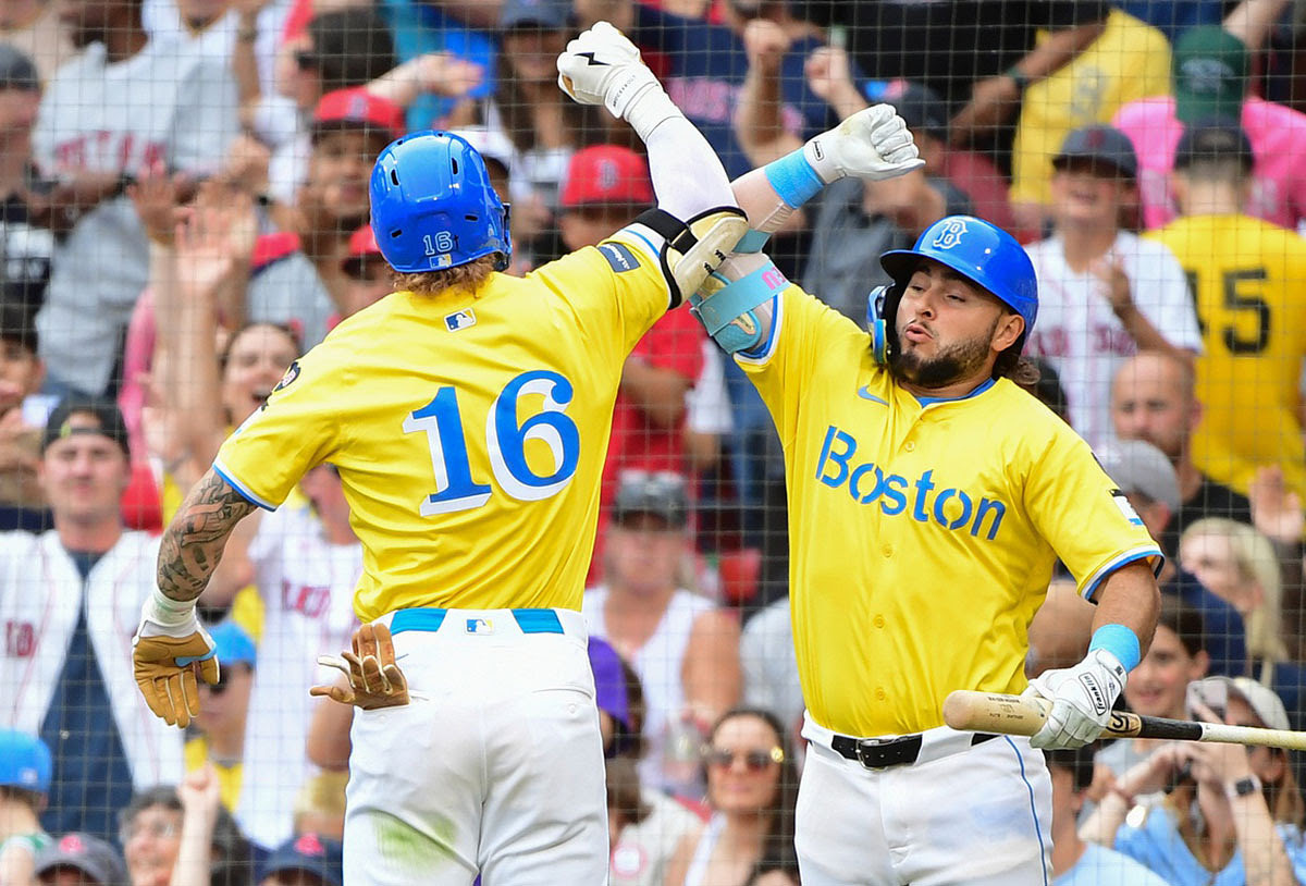 Boston Red Sox center fielder Jarren Duran (16) reacts with right fielder Wilyer Abreu (52) after hitting a home run during the sixth inning against the San Diego Padres at Fenway Park.