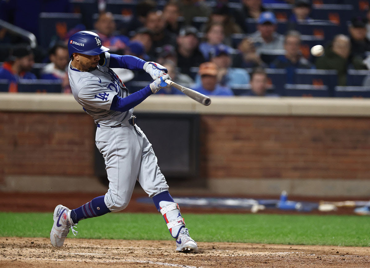 Los Angeles Dodgers right fielder Mookie Betts (50) hits a home run during the sixth inning against the New York Mets during game five of the NLCS for the 2024 MLB playoffs at Citi Field.
