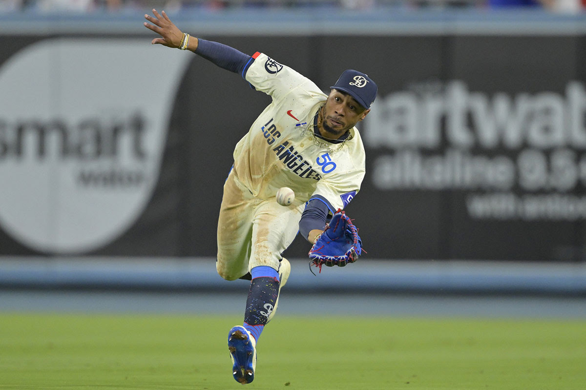 Los Angeles Dodgers shortstop Mookie Betts (50) makes a running catch off a ball hit by Cleveland Guardians right fielder Lane Thomas (8) in the eighth inning at Dodger Stadium.