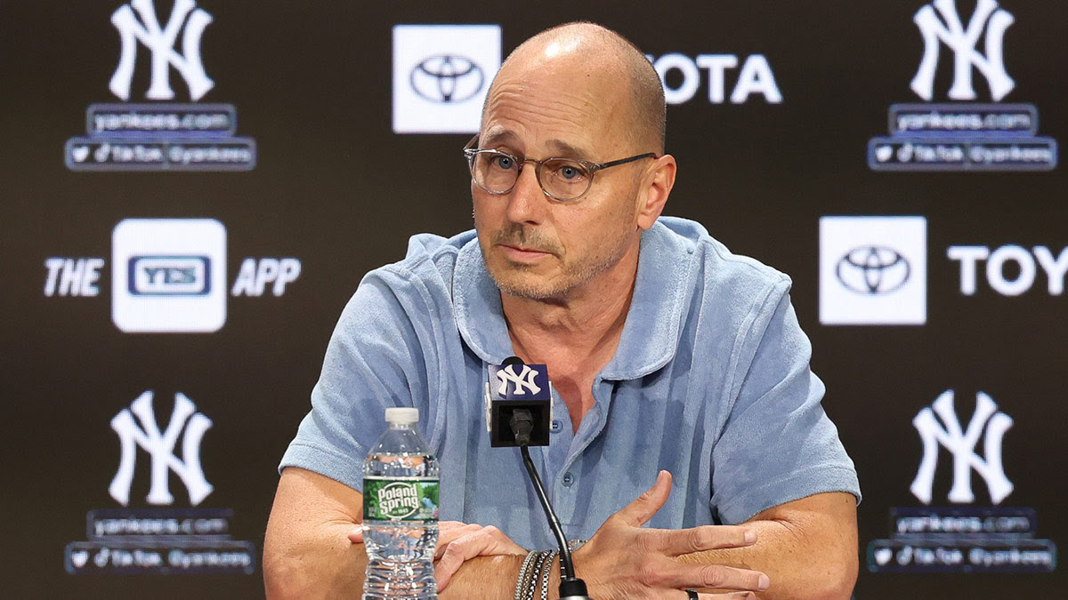 New York Yankees general manager Brian Cashman talks with the media before the game between the Yankees and the Washington Nationals at Yankee Stadium.