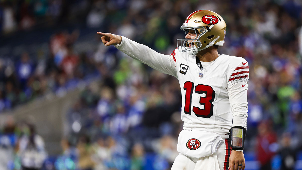 San Francisco 49ers quarterback Brock Purdy (13) celebrates after throwing a touchdown pass against the Seattle Seahawks during the fourth quarter at Lumen Field