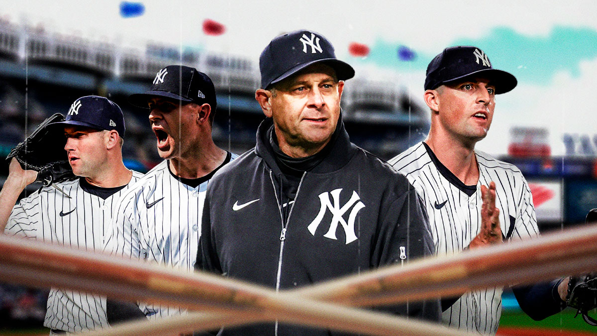Yankees relievers Clay Holmes, Tim Mayza and Jake Cousins, manager Aaron Boone