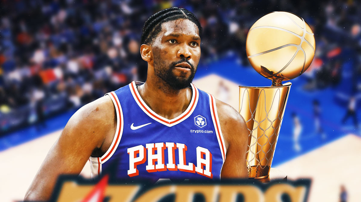 76ers' Joel Embiid next to a Larry O'Brien trophy
