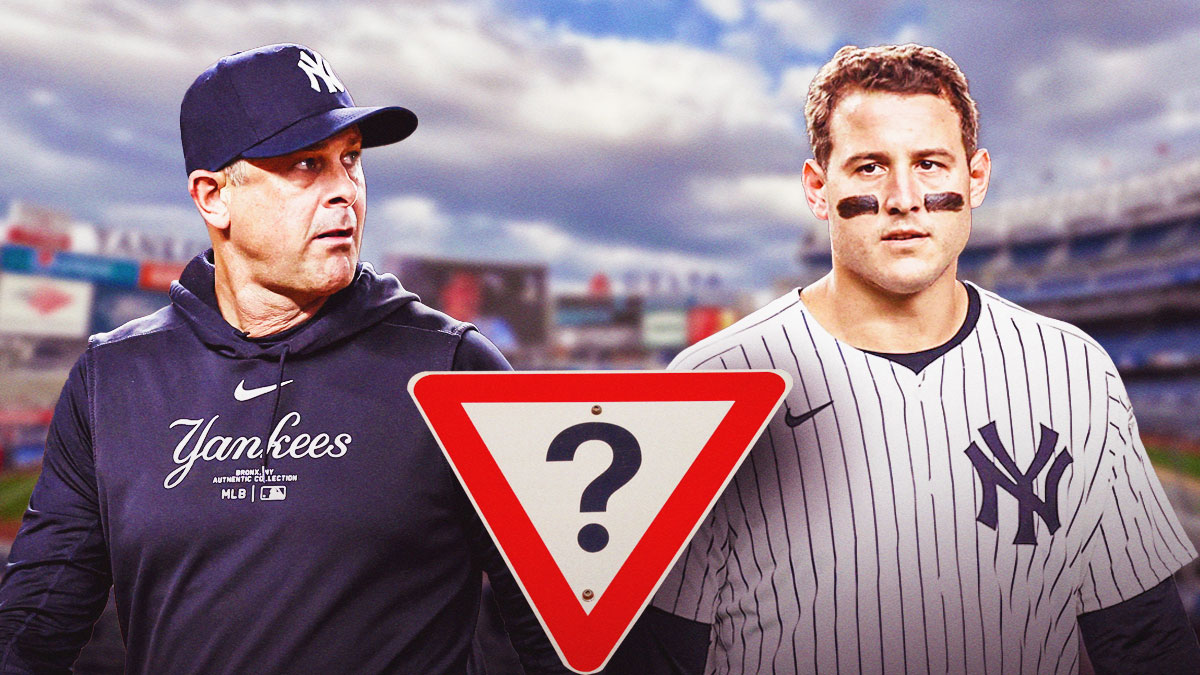 Yankees' Aaron Boone and Anthony Rizzo with a big question mark on a sign between them