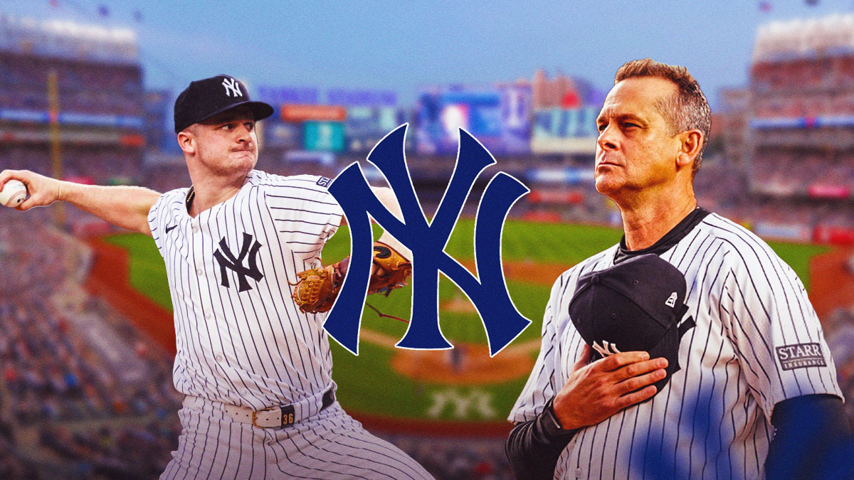 Aaron Boone watching Yankees' Clarke Schmidt throwing a pitch