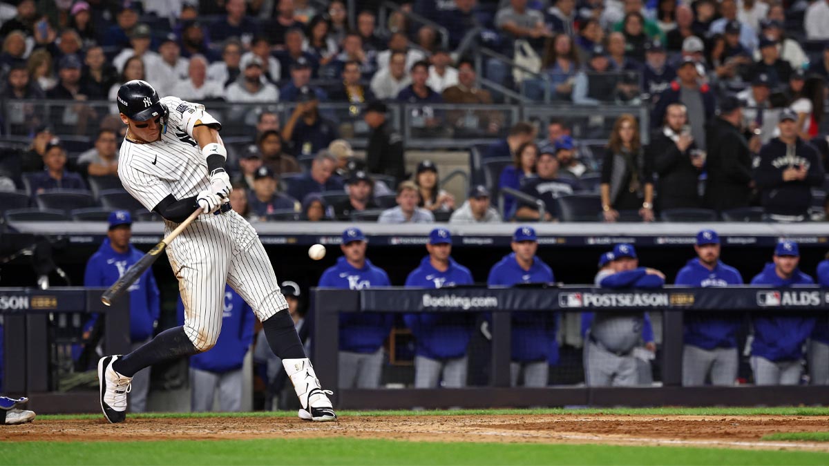 New York Yankees outfielder Aaron Judge (99) hits a single against the Kansas City Royals in eighth inning during game two of the ALDS for the 2024 MLB Playoffs at Yankee Stadium.