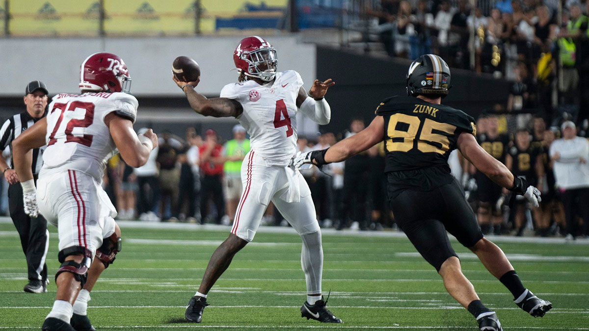 Alabama Crimson Tide quarterback Jalen Milroe (4) throws against Vanderbilt Commodores defensive lineman Linus Zunk (95) during their game at Vanderbilt Stadium in Nashville.