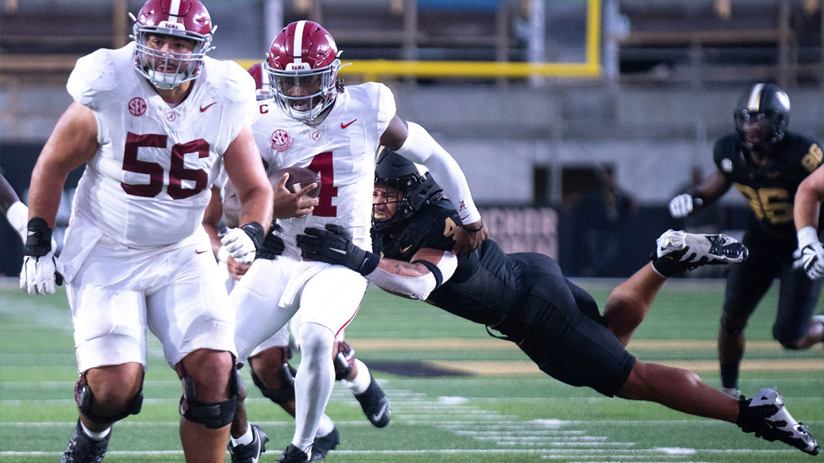 Alabama Crimson Tide quarterback Jalen Milroe (4) is brought down by Vanderbilt Commodores linebacker Bryan Longwell (4) during their game at Vanderbilt Stadium in Nashville, Tenn., Saturday, Oct. 5, 2024.