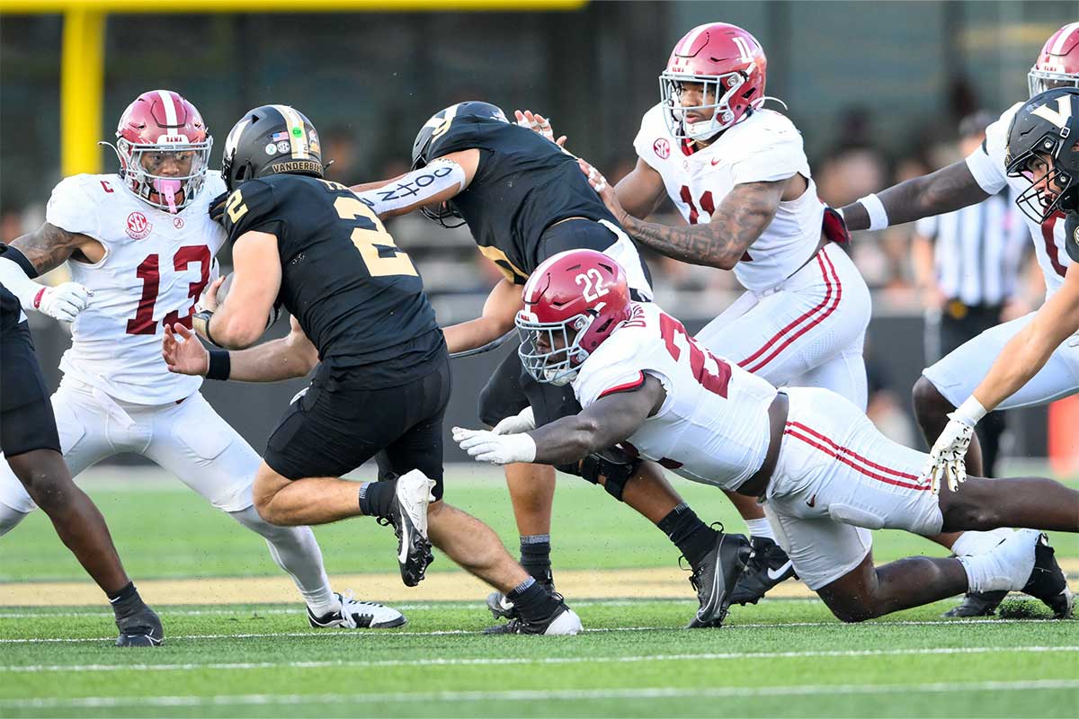 Alabama Crimson Tide defensive back Malachi Moore (13) and defensive lineman LT Overton (22) tackle Vanderbilt Commodores quarterback Diego Pavia (2) during the second half at FirstBank Stadium.