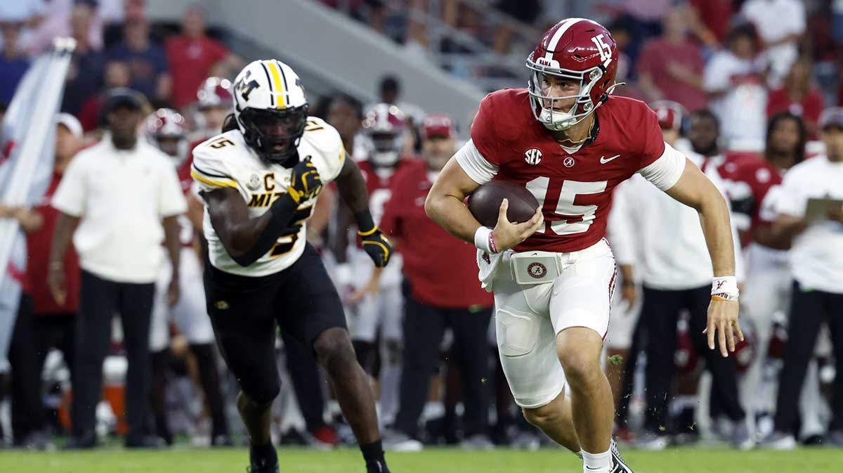 Alabama Crimson Tide quarterback Ty Simpson (15) scrambles for a first down against the Missouri Tigers during the second half at Bryant-Denny Stadium.
