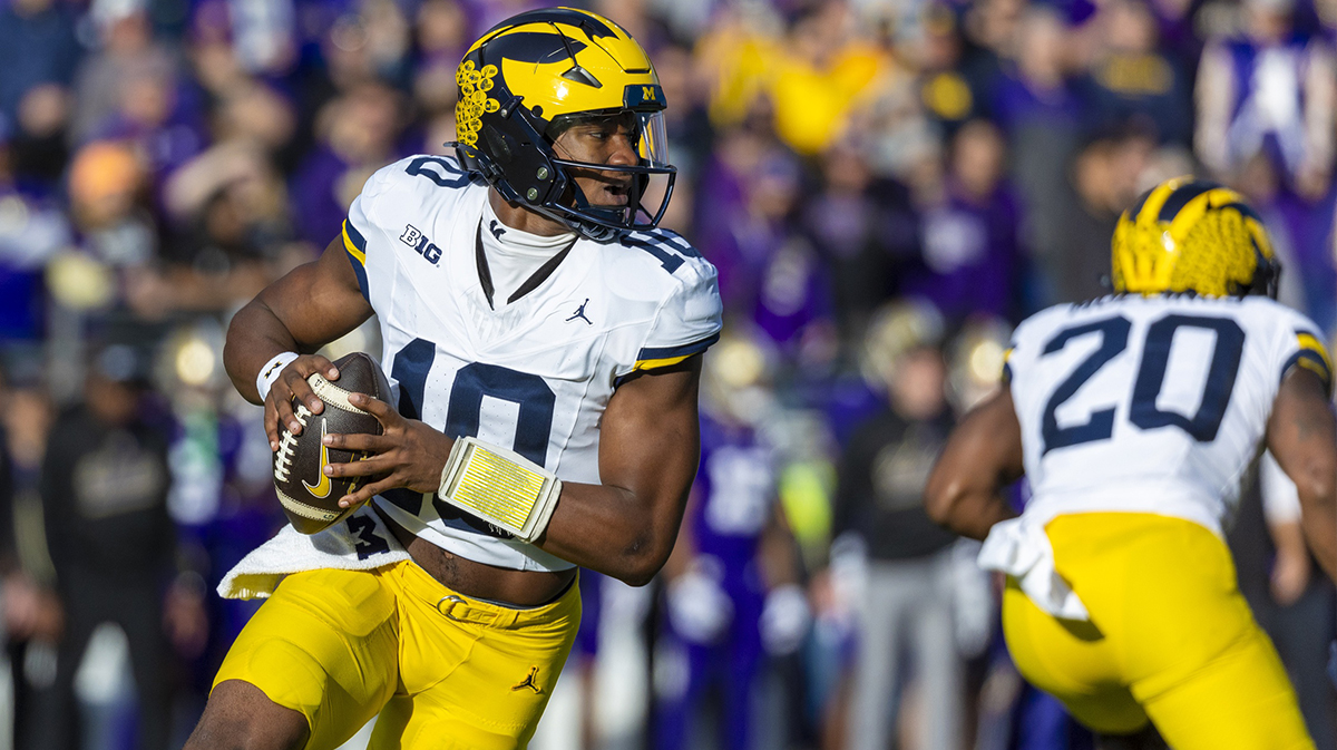 Michigan Wolverines quarterback Alex Orji (10) looks to pass against the Washington Huskies during the first quarter at Alaska Airlines Field at Husky Stadium.