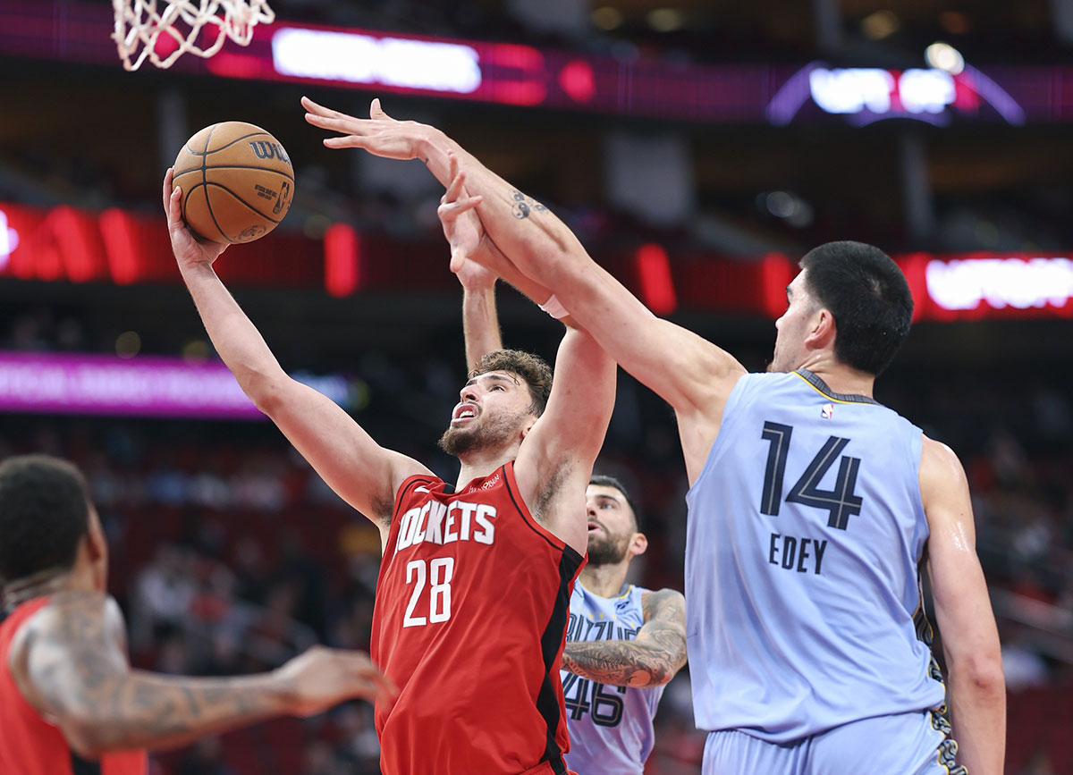 Houston Rockets center Alperen Sengun (28) shoots the ball as Memphis Grizzlies center Zach Edey (14) defends during the fourth quarter at Toyota Center.