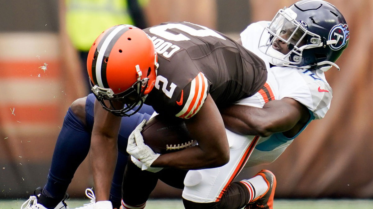 Tennessee Titans cornerback Roger McCreary (21) tackles Cleveland Browns wide receiver Amari Cooper (2) during the first quarter in Cleveland, Ohio., Sunday, Sept. 24, 2023.