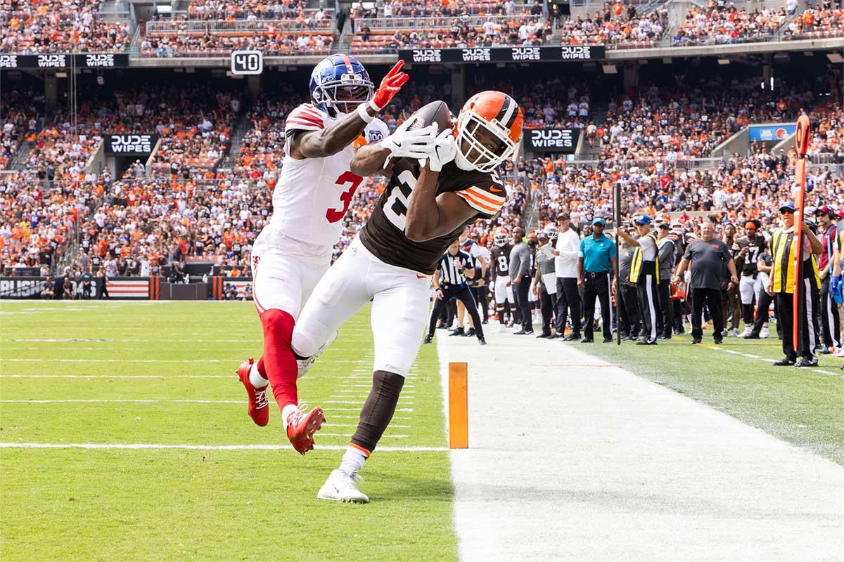 Sep 22, 2024; Cleveland, Ohio, USA; Cleveland Browns wide receiver Amari Cooper (2) makes a touchdown reception under coverage by New York Giants cornerback Deonte Banks (3) during the first quarter at Huntington Bank Field.