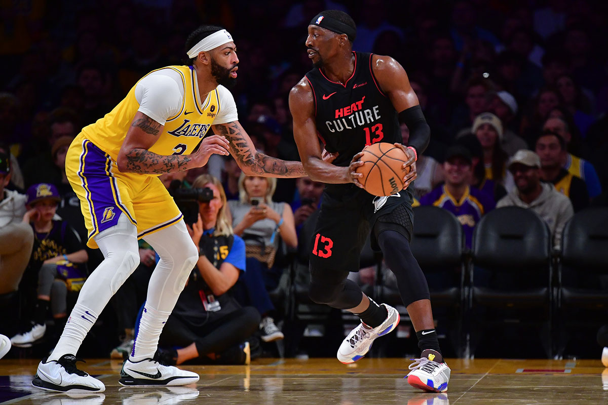 Miami Heat center Bam Adebayo (13) moves the ball against Los Angeles Lakers forward Anthony Davis (3) during the second half at Crypto.com Arena. 
