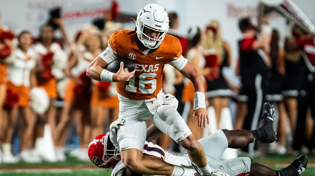 Texas Longhorns quarterback Arch Manning (16) tries to stay on his feet as Georgia Bulldogs linebacker Jalon Walker (11) goes for the tackle in the second quarter of the Longhorns' game against the Georgia Bulldogs at Darrell K. Royal Texas Memorial Stadium in Austin, Oct. 19, 2024.