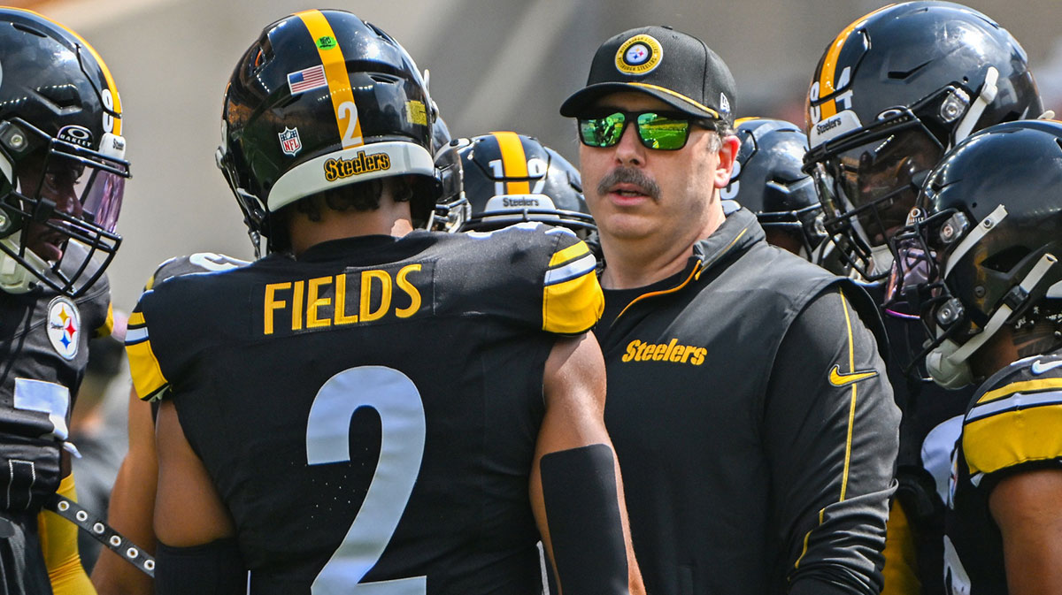 Pittsburgh Steelers offensive coordinator Arthur Smith talks with quarterback Russell Wilson (3) during warmups for a game against the Los Angeles Chargers at Acrisure Stadium.